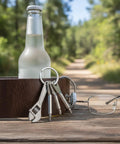 Go To Everyday Carry Keychain Multitool With Bottle Opener And Mini Wrench on table with glasses and bottle outdoors