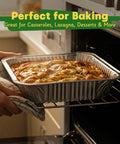 Person placing a casserole into an oven using Heavy Duty 9x13 Aluminum Pans With Lids, 25 Pack Disposable Foil Bakeware.