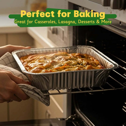 Person placing a casserole into an oven using Heavy Duty 9x13 Aluminum Pans With Lids, 25 Pack Disposable Foil Bakeware.