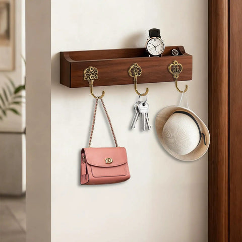 Wooden shelf with Ten Pack Vintage Metal Wall Hooks Set With Bronze Finish holding bag, keys, and hat