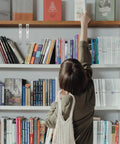 Bookshelf with books and 4 Pcs Stainless Steel Corner Brackets with right angle design and countersunk mounting holes visible.