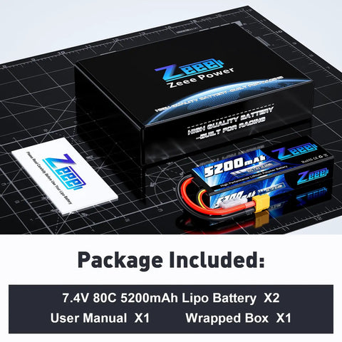 2S 5200mAh RC LiPo Battery 7.4V 80C With XT60 Plug Hard Case, battery pack with manual and box on grid surface.