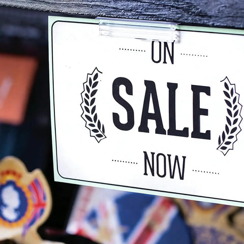 30 Pack 3x1 Inch Sneeze Guard Gripper Sign Holders With Adhesive For Desks, Shop Floor Displays, Wall Mounts, Store Vendor Events, Warehouse, Clear Great For Counters, Displays And Shelves On The Shop Floor. Clear plastic sign holder clipping a sale sign to a sneeze guard