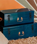 Stacked blue metal storage boxes on a rug with locks and handles, unrelated to Beefy Heavy Duty Metal Toggle Latch products.