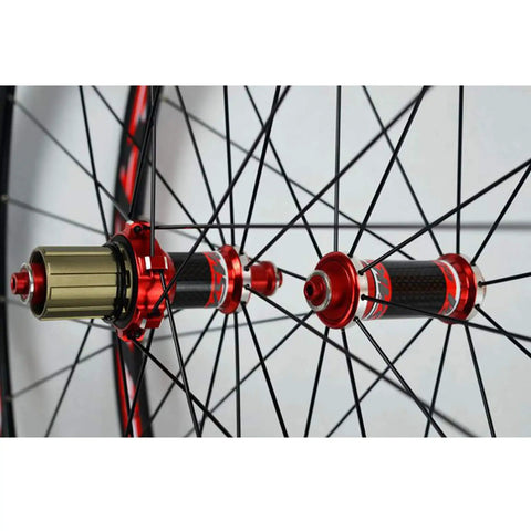 700C Road Bike Wheelset With Carbon Hub And 30mm Aluminum Double Wall Rim Quick Release Front And Rear Caliper And V Brake Compatible Seven to Eleven Speed Cassette Ready Matte Black close-up of carbon hub and spokes in red accents.