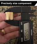 Close-up of brass shifter bushing for MX-5 Miata, held in digital caliper jaws