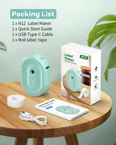 Compact Bluetooth Label Maker With Built In Rechargeable Battery And Ink Free Direct Thermal Printing For Effortless Home Organization And Straight Up Reliable Daily Labeling Jobs In Cool Green, accessories on table.