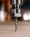 Close-up of SpeTool spiral router bit, 1/4 in diameter and shank, solid carbide, installed in router collet