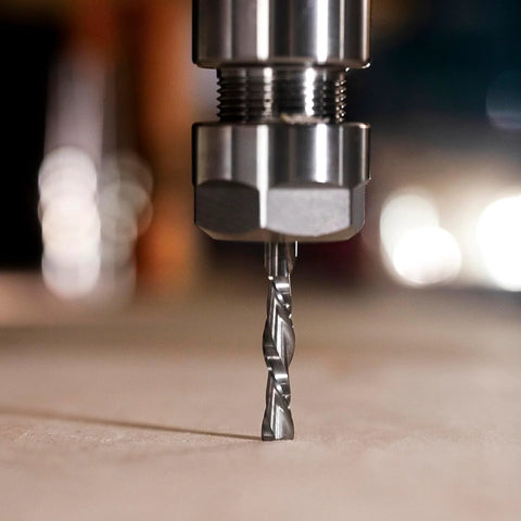 Close-up of SpeTool spiral router bit, 1/4 in diameter and shank, solid carbide, installed in router collet