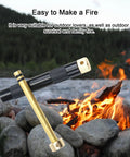 Compact Air Compression Fire Starter With Durable Metal Body for Camping shown in front of a campfire outdoors