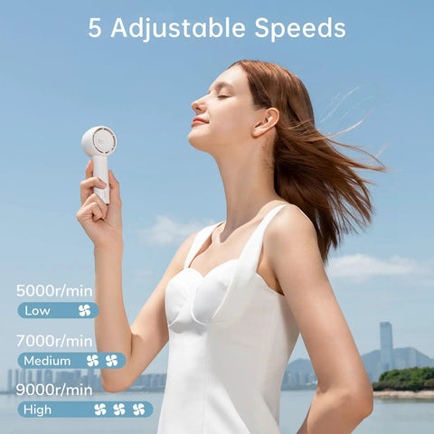 Woman using Bladeless Mini Portable Fan With Safe Design Turbo Handheld Breeze 5 Speed Modes USB Rechargeable Up To 16 Hours Cool Time Pocket Sized Travel Buddy Perfect Gift For Women And Girls