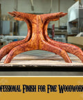 Premium Non Toxic Oil Based Wood Stain Pigment Kit With Hella Fade Resistant Black Color For Smooth Handy Projects And Top Shelf Furniture Refinishing That Delivers A Knockout Finish On Any Surface. Detailed view of a finely crafted wooden table base in a workshop.
