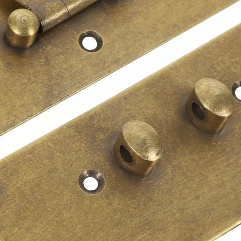 Close-up of vintage brass hasp latch buckle mechanism for jewelry boxes and retro wooden cases with gold antique finish