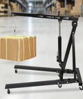 Folding Hydraulic Engine Hoist Cherry Picker 2 Ton 4400 Lbs Capacity Heavy Duty Carbon Steel Shop Crane lifting a box.