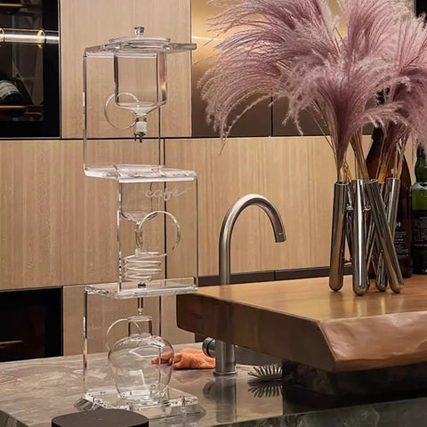 Topnotch Cold Brew Coffee Maker With Slow Drip Ice Tank And Large Capacity Glass Carafe On Solid Wood Base in a modern kitchen setting.
