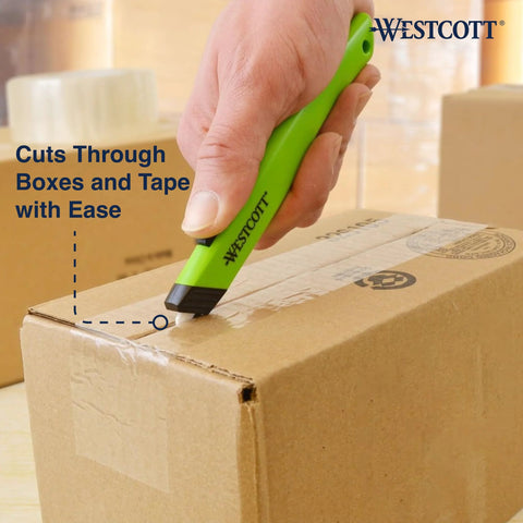 Westcott safety ceramic box cutter with green handle cutting a cardboard box (close-up view)