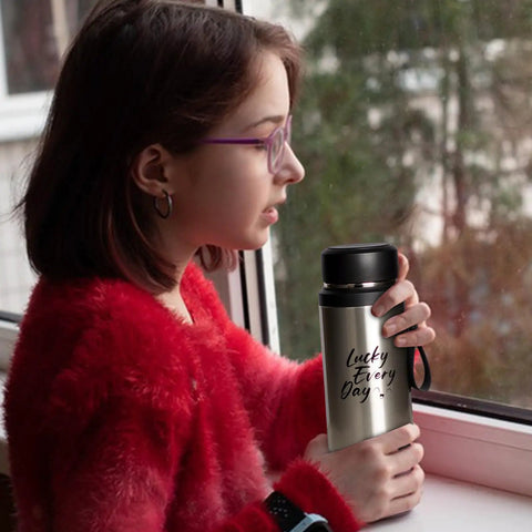 Person holding Insulated Water Bottle For On The Go Hydration 800ml Stainless Steel Flask with black cap by a window