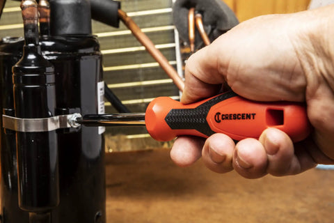 Using Quarter Inch Drive Dual Material Bit Holding Screwdriver Handle With Ergonomic Balance Grippy Oil And Solvent Resistant Grip Full Polish Chrome Shank Pro Grade Quality Meets ANSI ASME Specs on a machinery bolt