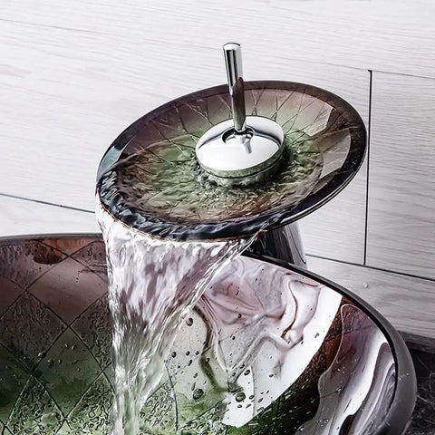 Top Shelf Tempered Glass Vessel Sink Built Tough As Nails With Slick Waterfall Faucet Flow pouring water into the basin.
