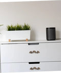 White dresser with Vintage Zinc Alloy Cabinet Pull Handles 56x17mm 20pcs Mini Drawer Knobs, plant and speaker on top
