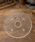 Six Inch Clear Acrylic Router Base Plate With Precision Pre Drilled Holes For DWP611 And DCW600B Compact Routers on wood surface.