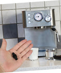 Person holding Insulated Rubber Steam Wand Sleeve For Camping Coffee Makers And Espresso Gadgets Durable Pipe Insulation Cover For Steam Pipe Lightweight Portable Protector in front of espresso machine.