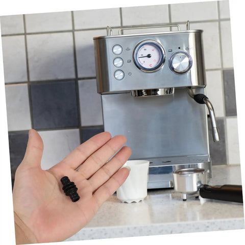 Person holding Insulated Rubber Steam Wand Sleeve For Camping Coffee Makers And Espresso Gadgets Durable Pipe Insulation Cover For Steam Pipe Lightweight Portable Protector in front of espresso machine.