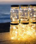 Mason jars illuminated by warm white battery operated fairy string lights 10 ft copper wire set waterproof indoor outdoor decor for weddings.