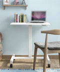 Adjustable Mobile Laptop Stand With Smooth Rolling Casters Portable Standing Desk in white, 690x480x760 mm, beside chair.