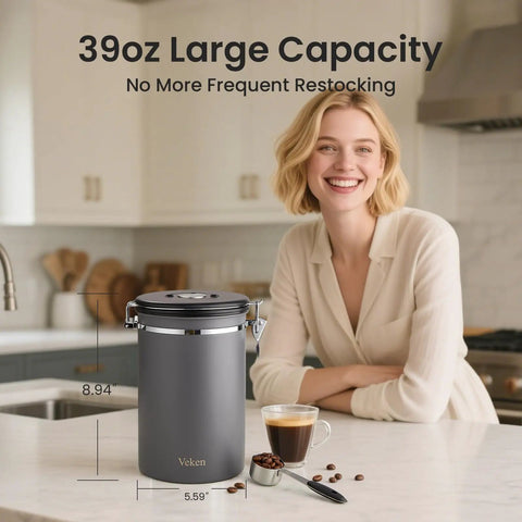 Airtight Stainless Steel Coffee Canister 39oz Large Storage Container with lid, gray, on kitchen counter beside smiling woman and coffee cup.