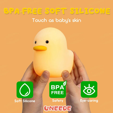 Hands holding a Cute Duck Night Light For Nursery And Bedroom, Rechargeable Silicone Baby Lamp With Touch Sensor, gentle glow.