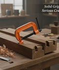 Heavy Duty Orange Iron G-Clamp For Woodworking And Diy Projects on wooden planks, securely holding materials for precise assembly tasks.