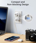 World To US Plug Adapter 2 Pack Universal Travel Power Converter plugged into US outlet near laptop and camera.
