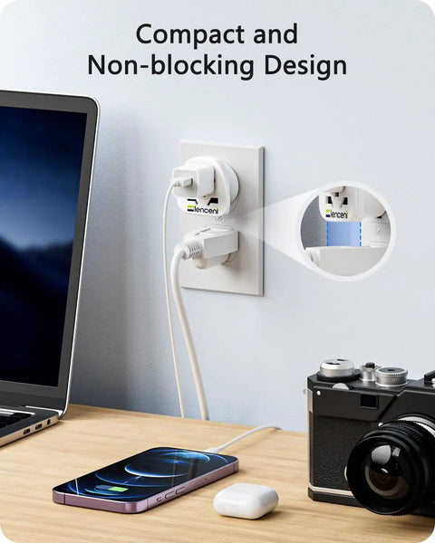 World To US Plug Adapter 2 Pack Universal Travel Power Converter plugged into US outlet near laptop and camera.