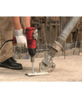 Person using drill with Kwik Hus EZ Three Eighth Inch By Four Inch Concrete And Masonry Screw Anchor on concrete surface