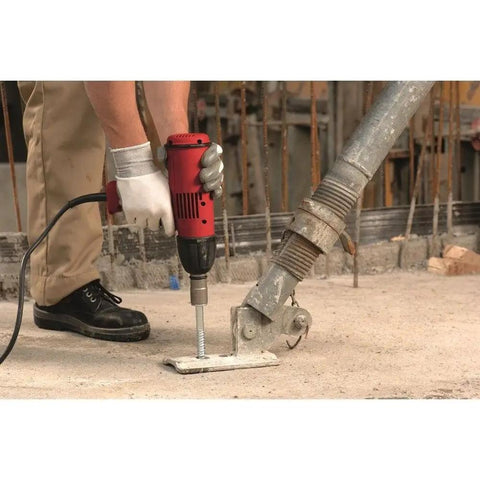 Person using drill with Kwik Hus EZ Three Eighth Inch By Four Inch Concrete And Masonry Screw Anchor on concrete surface