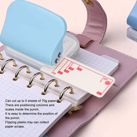 3 Hole Paper Punch Handheld, 5 Sheets Capacity, Metal Body With Slipproof Grip And Plastic Cover in use on B5 paper