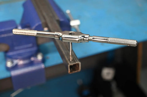 Close-up of Five Sixteenth Twenty Four Inch Tap And Drill Set With Plug Style Tap For Easy Start And Precise Thread Cutting in action