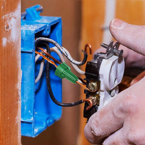 Close-up of hands using Winged Ground Wire Connector Nuts With Hole, Spring Loaded Wire Nuts For Safe Electrical Connections.