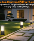 Rock Solid 15.75 Inch Outdoor Bollard Path Lights With Knockout Aluminum Frame And Frosted Glass Shade casting light along a stone pathway.