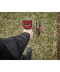 Rugged 12 Inch Digital Measuring Wheel With IP54 Backlit Display in hand measuring distance on grass surface.
