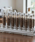 Hype Building Daily Grind Storage Kit With Airtight Single Dose Espresso Canisters on a countertop with coffee beans.