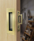 Recessed Finger Flush Pulls With Edge Pull Antique Brass 6 Inch Pop Up Pull installed on a wooden pocket door
