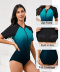 Women One Piece Rash Guard With Built In Bra Front Zip For Easy On Off No Fuss Convenience Short Sleeve Surfing Athletic Swimsuit UPF50 Full Lined Support Ombre Turquoise Black Size Large, front view.