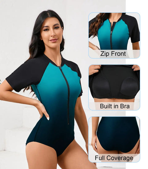 Women One Piece Rash Guard With Built In Bra Front Zip For Easy On Off No Fuss Convenience Short Sleeve Surfing Athletic Swimsuit UPF50 Full Lined Support Ombre Turquoise Black Size Large, front view.