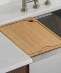 Solid Bamboo Cutting Board For Workstation Sinks Over The Sink Prep Board shown clipped on the ledge with no slip surface.