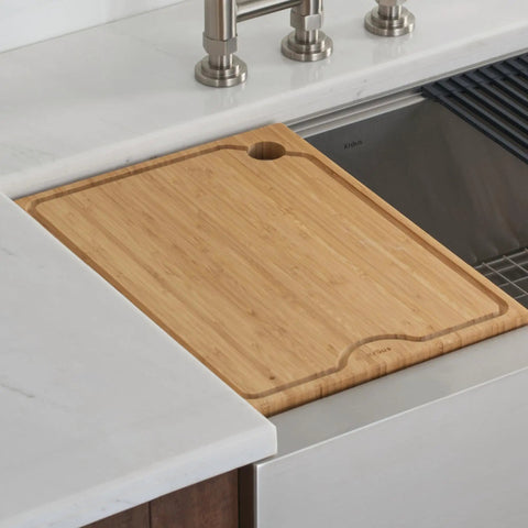 Solid Bamboo Cutting Board For Workstation Sinks Over The Sink Prep Board shown clipped on the ledge with no slip surface.