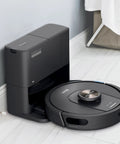 Robot Vacuum With Matrix Clean And Precision Mapping Self Empty Base With 30 Day Capacity Bagless Powerful Pet Hair Cleaning WiFi Enabled Black Renewed on charging dock in bathroom with gray and white interior.