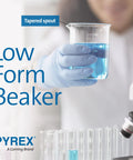 Gloved hand holding Griffin Borosilicate Glass Beaker Low Form With Pouring Spout 600 mL Two Pack in a lab setting