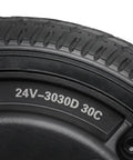 Close-up of a 6.5-inch road tire on a wheel, black rubber with tread and 24V-3030D 30C on the sidewall.